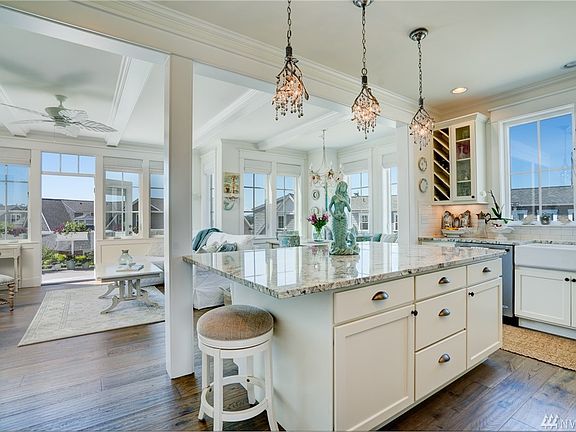A bright and open floor plan is  anchored by this generous kitchen island - sure to be the focal point for all your entertaining