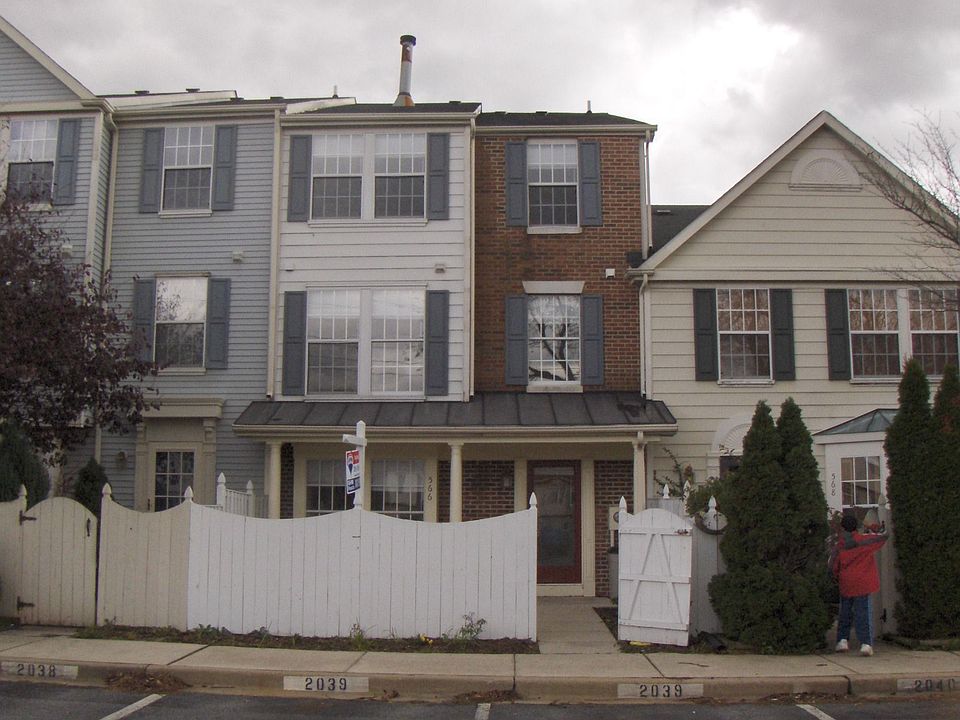 Red brick and white siding home in middle