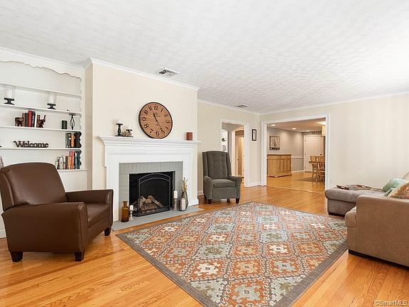 Living room with fireplace and beautiful hardwood floors.