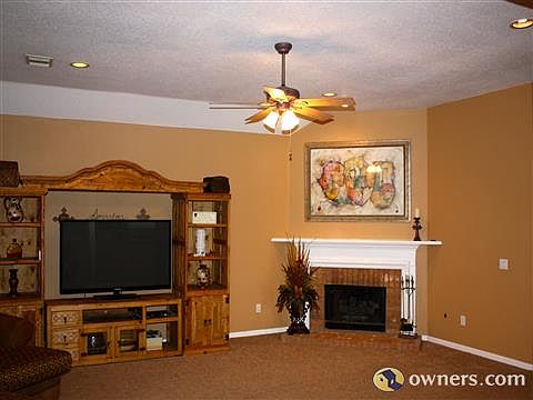 Spacious family room with vaulted ceilings and recessed lighting