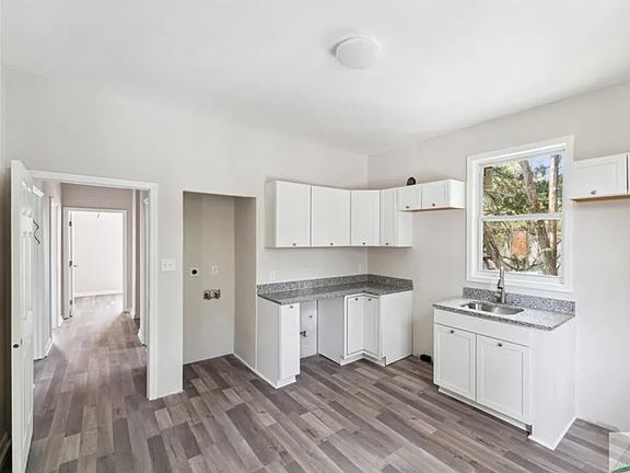 View from kitchen into main hallway (new appliances and W/D just added!)