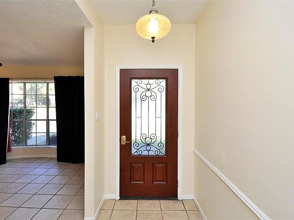 Leaded glass front door. Bay window in front dining area or use this space for home office or extra TV/gaming room.