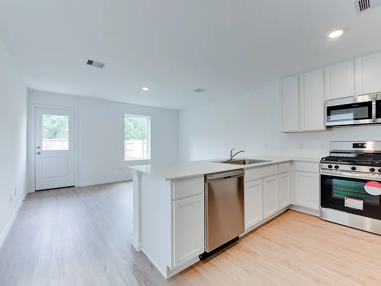 Kitchen opens up to living room