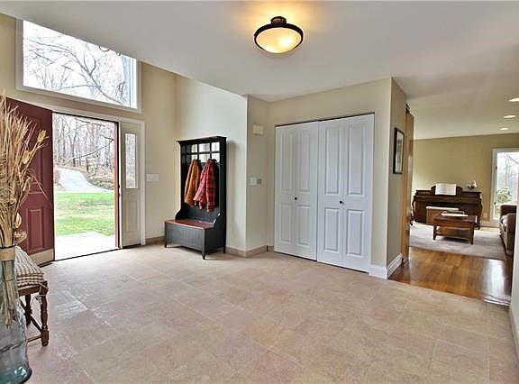 Grand foyer entry with tiled floor and generous coat closet.