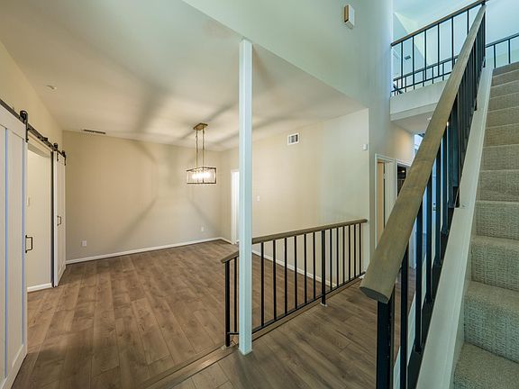 Entrance to home with all new flooring and lighting