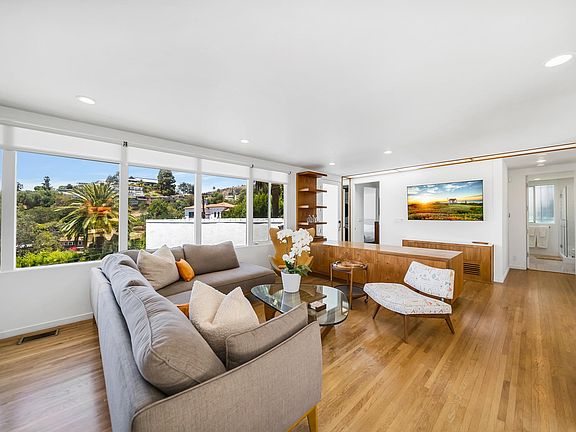Large living room with mid-century modern design and gorgeous city views