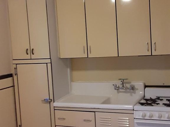 This is the second room. It is a spacious full kitchen with cabinets and oven and a window. All of the windows have been replaced with energy efficient double pane windows! All the walls in this apartment have freshly painted walls!