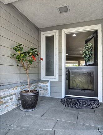 Welcome Dutch door entry. Note the stacked stone, which is on the front of the house and consistently used in the backyard hards