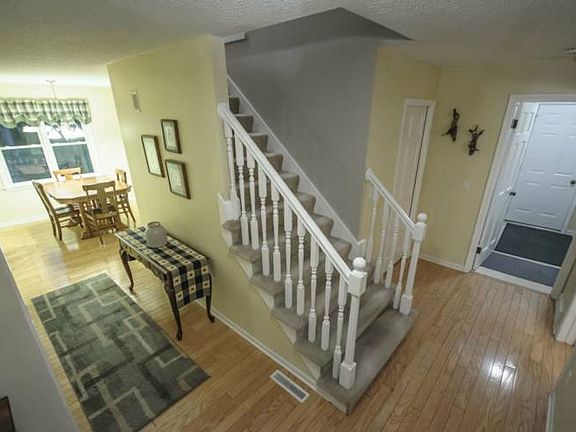 Welcome home!  The front entry space invites you into the warm main level with white trim, neutral paint and Bruce hardwood floors.  Kitchen ahead and living room off to the left.  Main floor laundry room off to the right with access to the garage.