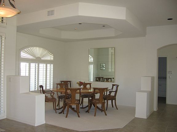 Formal dining room has spacious feel. Note the ceiling design.