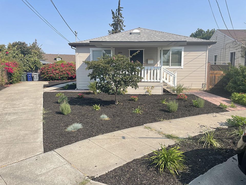 Front of home with long driveway on one side
