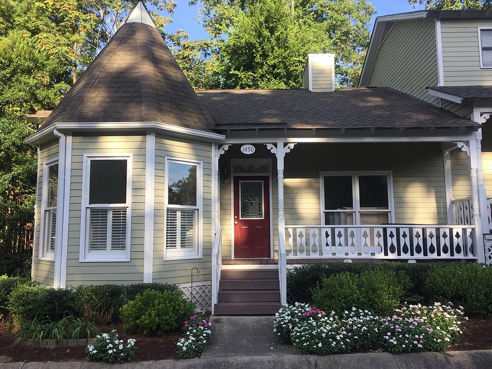 The flat is in a Victorian-styled community. It's an end unit with large windows and a private deck.