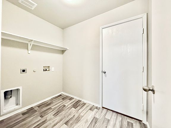 Laundry room with FRESH PAINT paint and NEW flooring