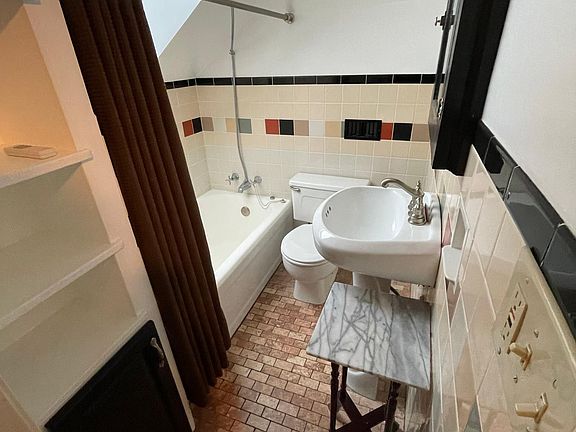 Water closet with skylight and solar-powered shade