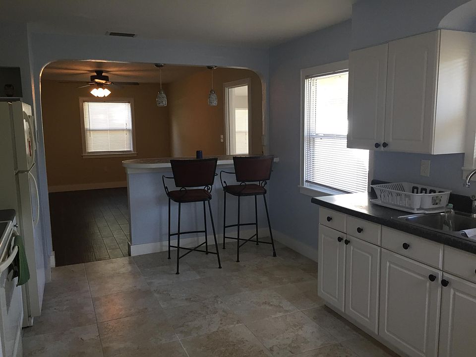 View of Kitchen from the laundry room. Very wide open kitchen. Chairs are included for the breakfast bar.