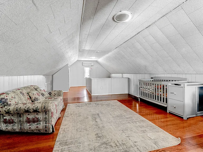 Top floor bedroom boasts original pine flooring, and lots of room for multiple seating areas.