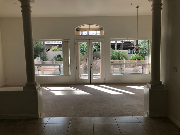 Living Room/Dining Room overlooking fenced pool and spa.