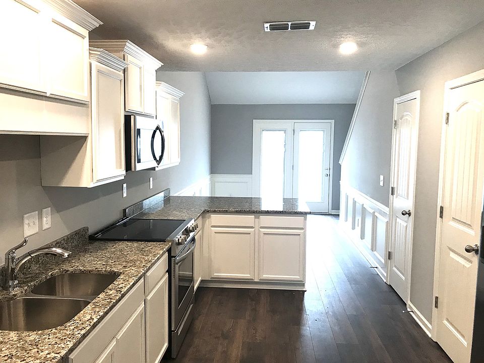 Looking through kitchen and back to breakfast area and French door that leads out to private patio.