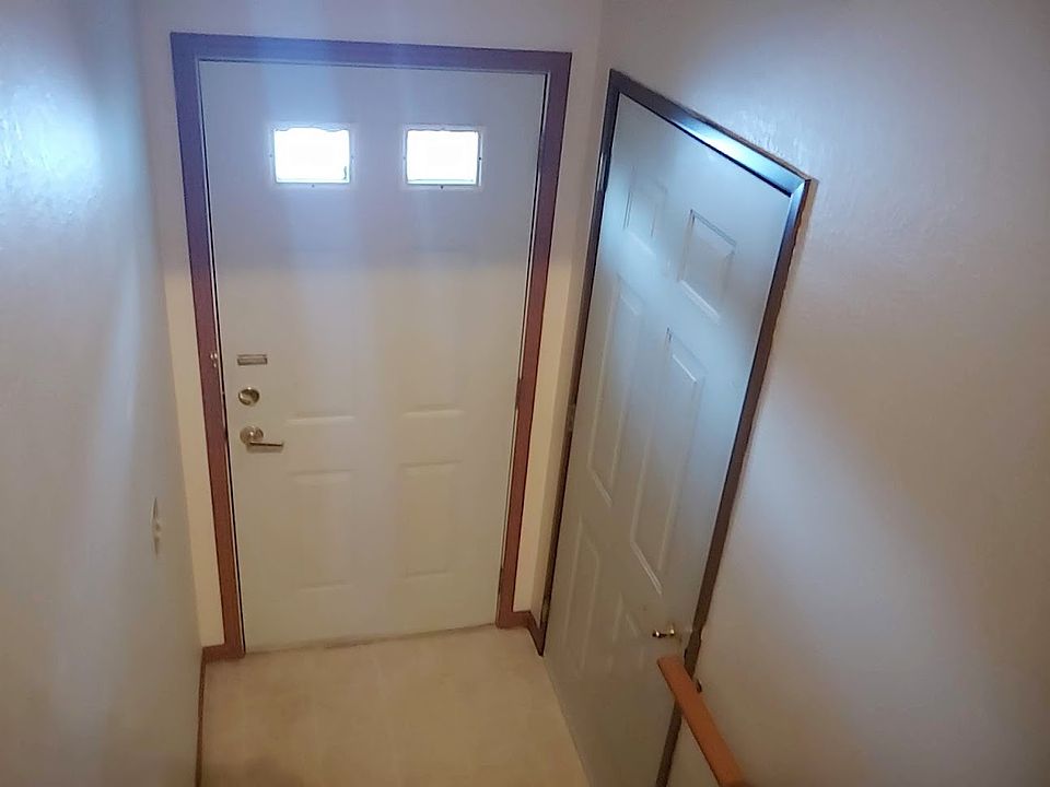 Private entrance to unit with an entrance door to the garage