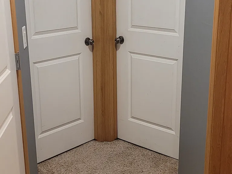 Upstairs hallway - 2 bedroom doors from bathroom. Laundry room is on the right.