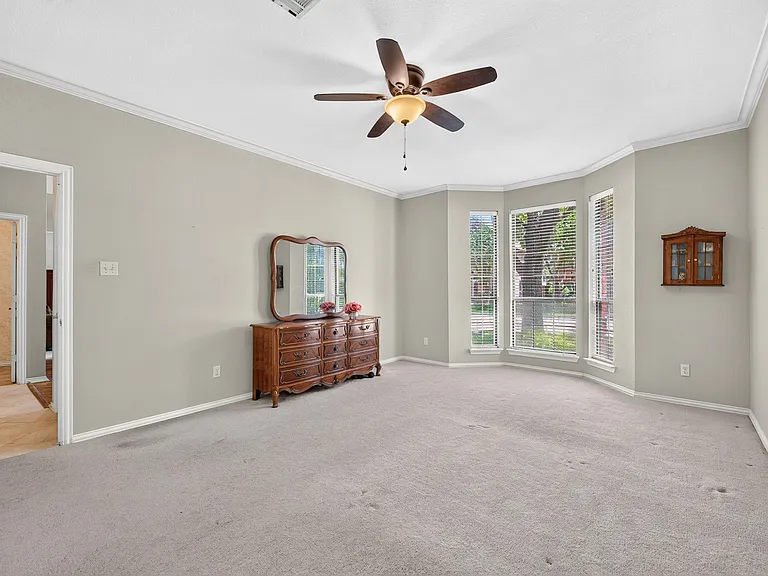 Primary Bedroom with bay window and vaulted ceiling