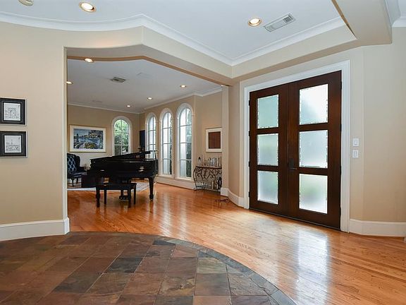 The Formal Living and Dining Rooms flank the Entry Hall.  Double mahogany wood doors with glass inserts open to the Entry.