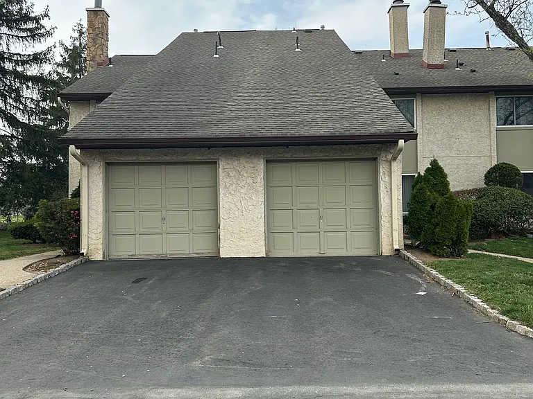 Front door entrance is to the left of the Left garage door