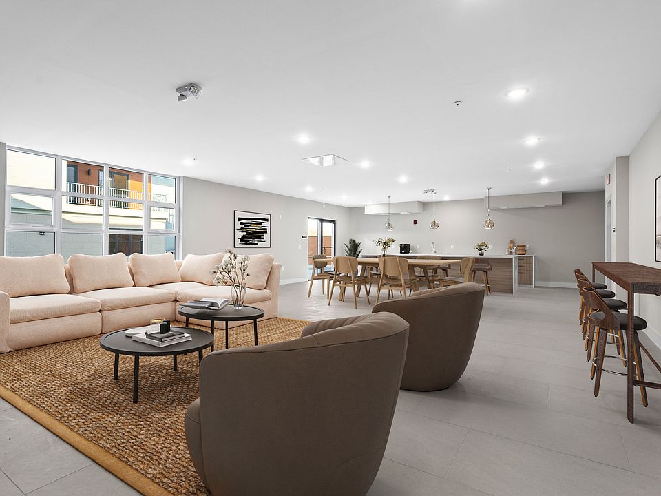 Located adjacent to the courtyard, the third-floor community room offers a refined setting for relaxation or entertaining. Thoughtfully designed with a full kitchen and a cozy fireplace, it provides both comfort and convenience.