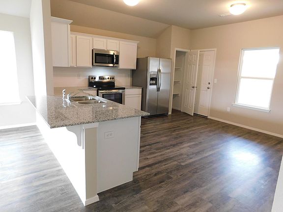 Great kitchen - breakfast bar, stainless steel appliances, stainless steel side-by-side refrigerator with ice/water in the door. Pantry! Plenty of room for your dining table here!