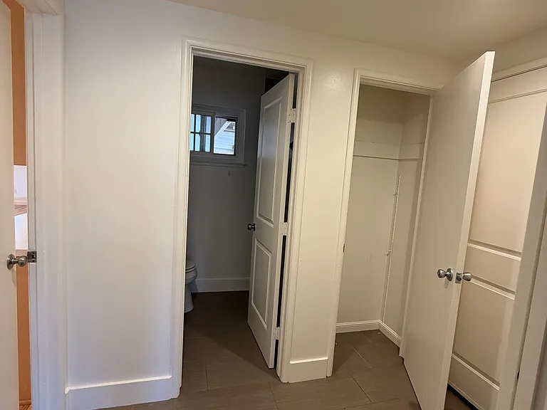 Downstairs bathroom with shower and closet. This is the only bathroom on the first floor. Pic taken from bedroom/flexroom door. Door to Right is garage. Door to the left is kitchen/family room.