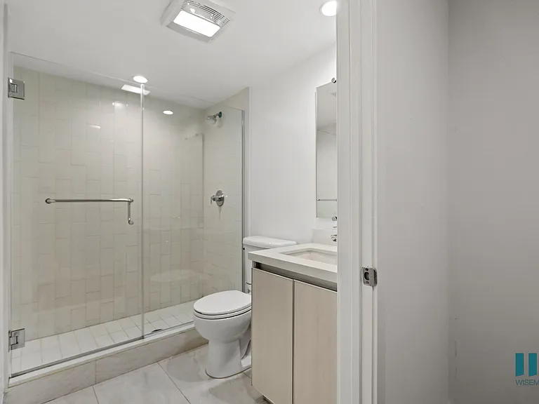 Bathroom with Walk-In Shower and Glass Door and Vanity Cabinet Storage