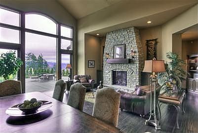 Formal living and dining with massive stone fireplace and the mountain beautifully framed in the flo