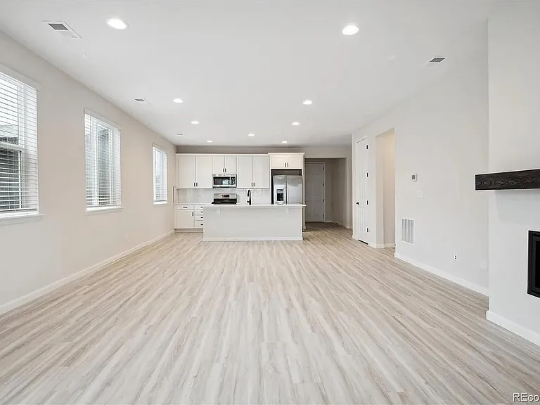 View from Back Patio to Open Floor Plan of Great Room / Dining / Kitchen