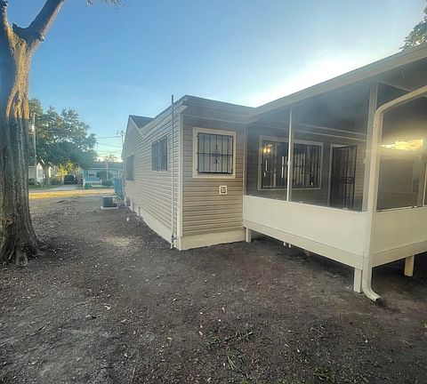 Side and back of the house with screen in back porch