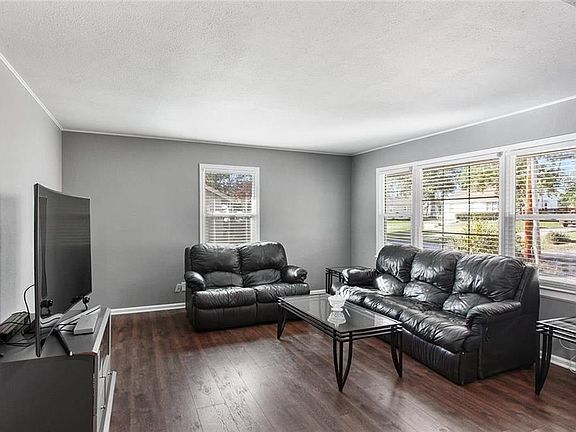 Enter into the spacious living room with hardwood floors and tons of light.