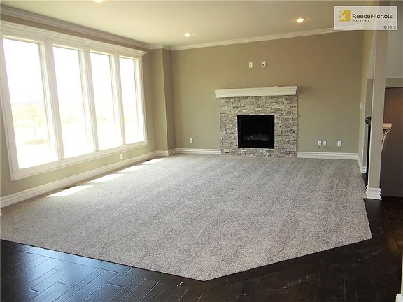 Great room has floor to ceiling windows allowing for natural light, gas fireplace and pre-wired for surround sound.