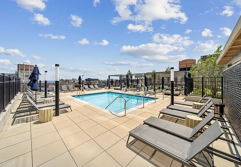Sun, swim, serenity _ a chic pool retreat where breezy vibes and skyline views invite endless unwinding.