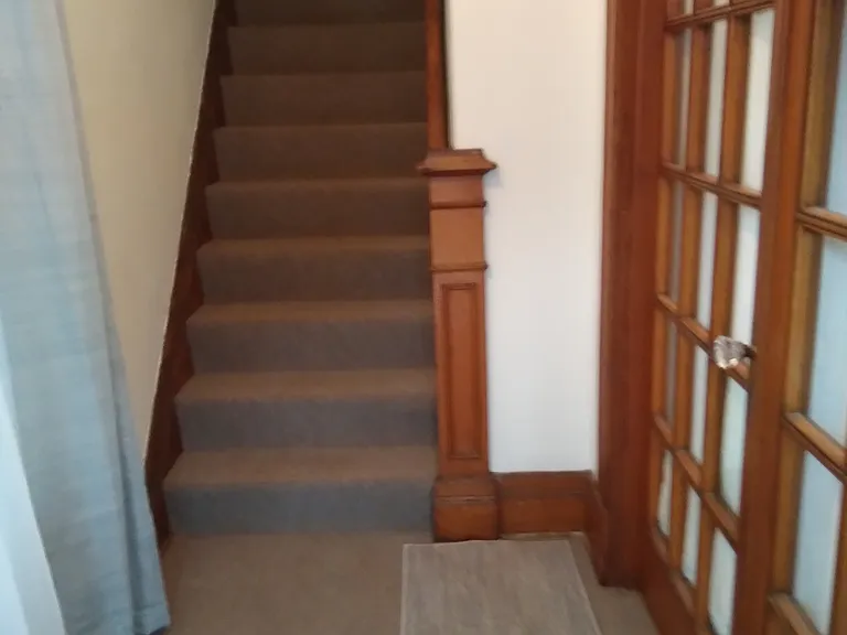 front entrance from shared front door. Apartment is upstairs, owner is side view of French Doors.