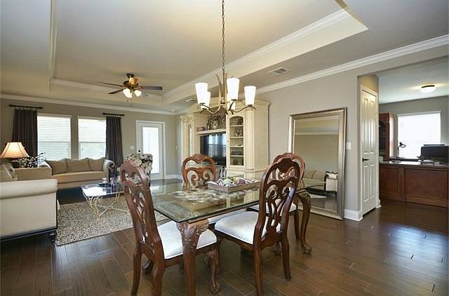 Wood floors span throughout the living area of this wonderful Sun city Texas Gray Myst, where a pop-