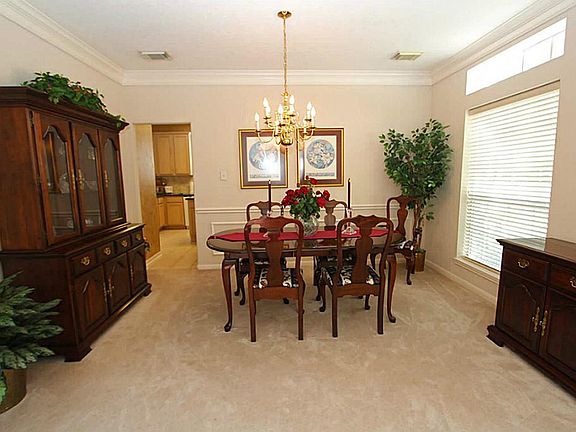 The formal dining room has crown molding and a large window with transom.