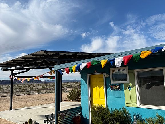 Front entrance looking Northwest (with Tibetan prayer flags, solar carport)