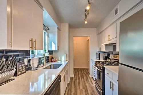 Marble quartz countertops and gold hardware throughout kitchen - 2300 Mission Hill Dr #101