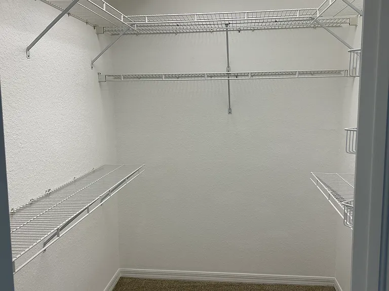 Walk-in closet in primary bedroom.