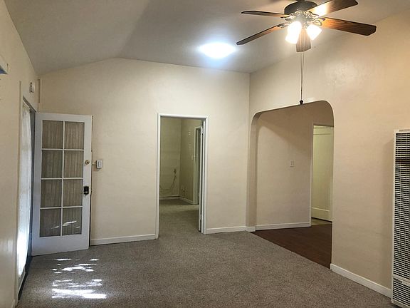 Spacious Living Room has French doors (Left). This view shows bedroom door and dining area archway. Bathroom has 2 doors: to bedroom and dining area.
