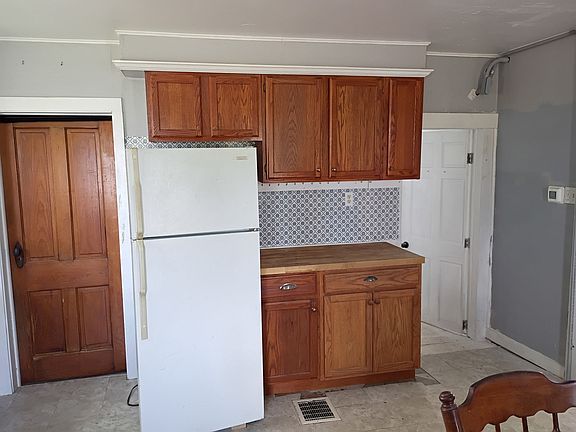 Kitchen with entrance to the bathroom into the far right to the living room. And the mudroom.