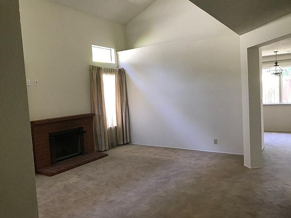 Living Room with transom windows, cathedral ceiling and fireplace.