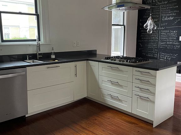 Spacious kitchen with gas range, room for bar seating, and an eat-in dining area