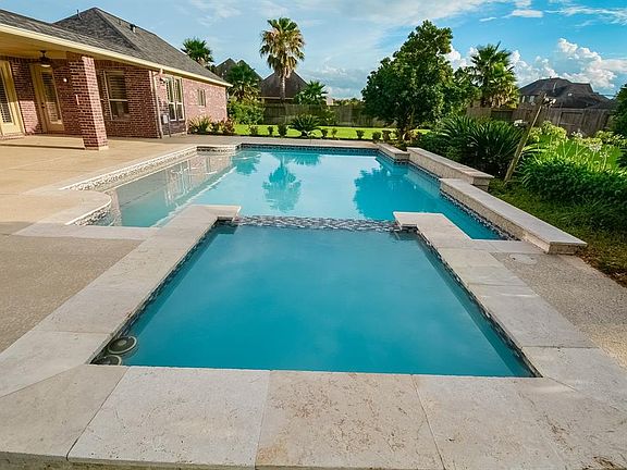 Dive in and enjoy your swim surrounded by beautiful landscaping!