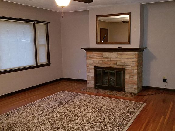 Living Room with electric fireplace insert, hardwood floor.