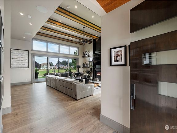 Be amazed as you enter to vaulted ceilings with impressive beams, custom features, high end finishes and lots of light and views>